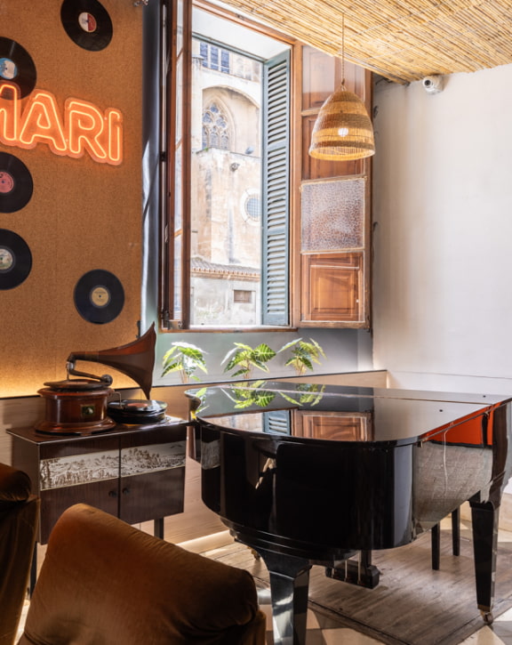 El Josemari Piano Piano and gramophone next to a window in the common areas